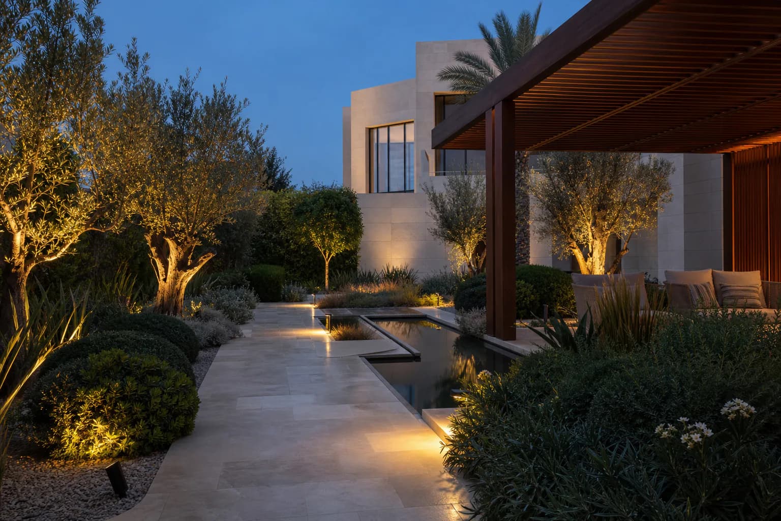 Contemporary planted garden with subtle path lighting after sunset